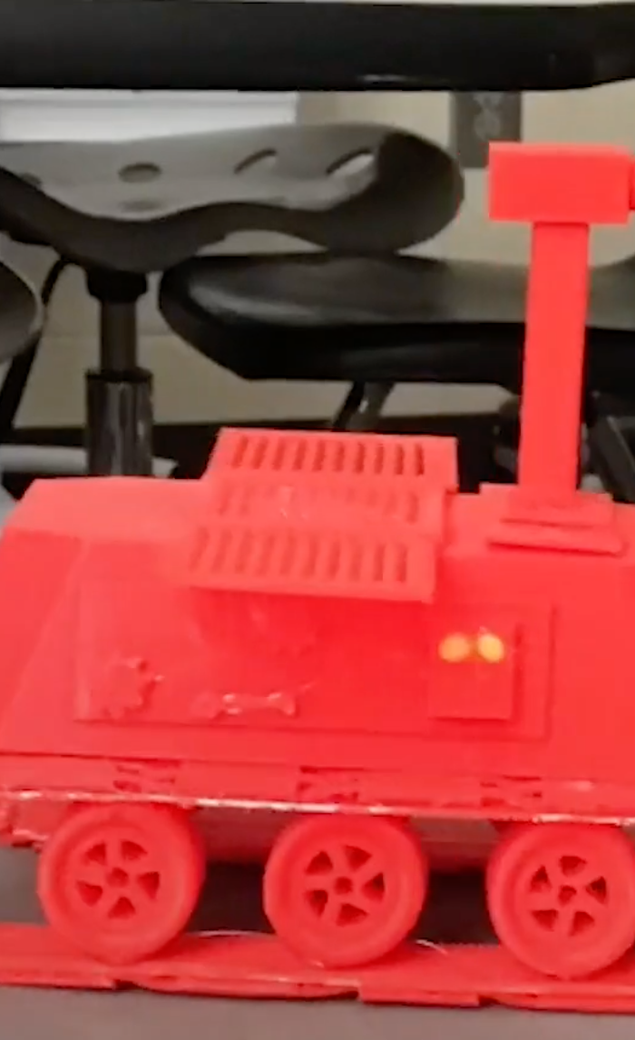 6th grade student at Richmond Hill Middle School holding a 3D printed Mars rover built with MakerBot Sketch Classroom